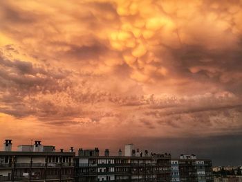High angle view of buildings against dramatic sky