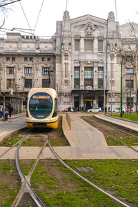 View of railroad tracks by buildings in city