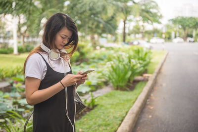 Young woman using mobile phone outdoors