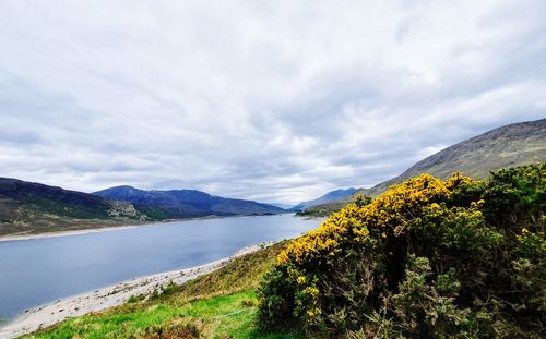 Scenic view of lake and mountains against sky