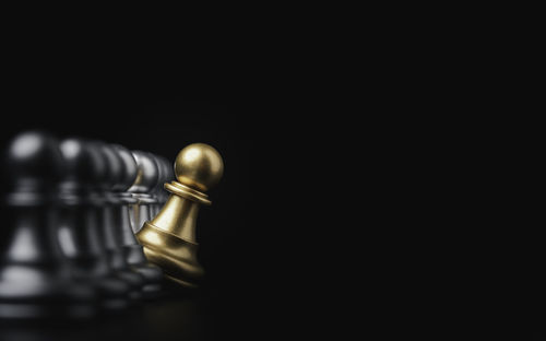 Close-up of chess pieces against black background