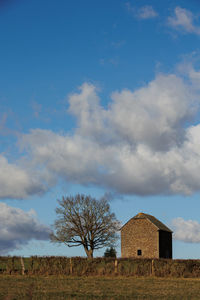 House on field against sky