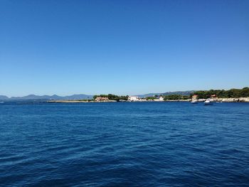 Scenic view of sea against clear blue sky