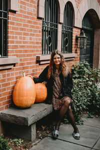 Portrait of woman against building