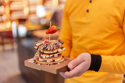 Midsection of man holding cake