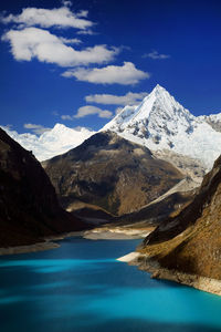 Scenic view of lake and mountains against sky 
