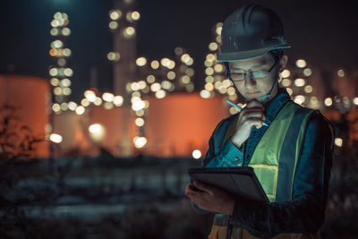 Young man using smart phone at night