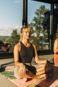 Woman sitting cross-legged doing meditation at retreat center