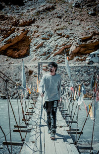Portrait of young man standing on rock