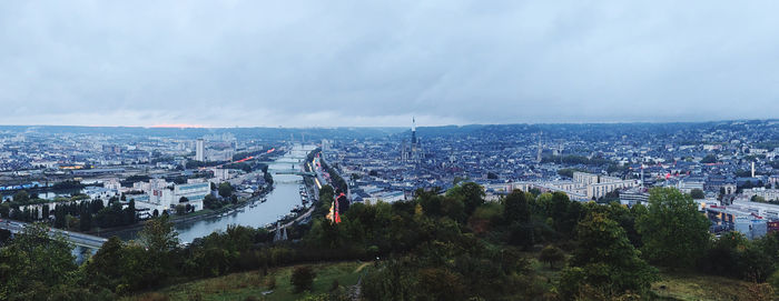 High angle view of townscape by sea against sky