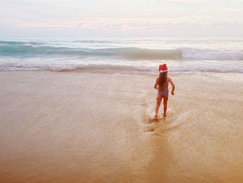 Full length of girl walking at beach