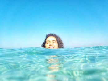 Portrait of woman swimming in pool