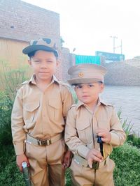 Portrait of father and son standing outdoors