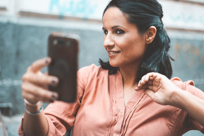 Portrait of woman using mobile phone