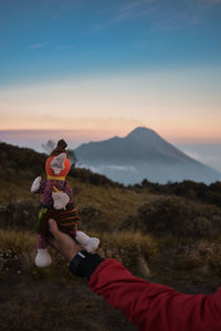 Women on field against mountains during sunset