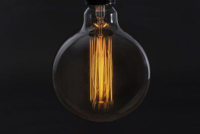 Incandescent lamp on a black background close-up. electricity concept