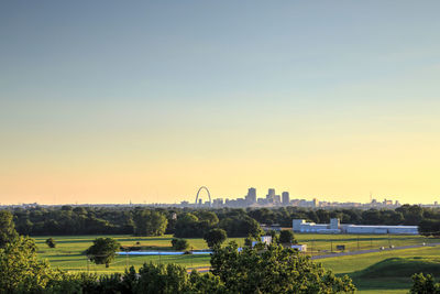 Scenic view of field against clear sky during sunset