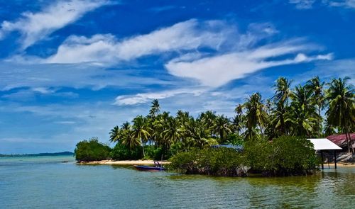 Scenic view of calm sea against cloudy sky