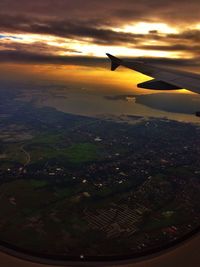 Cropped image of airplane flying over landscape