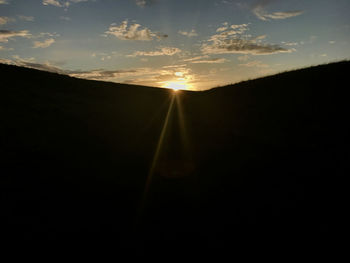 Silhouette landscape against sky during sunset