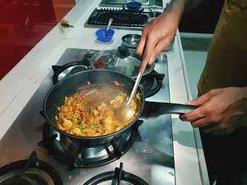 Midsection of man preparing food in kitchen