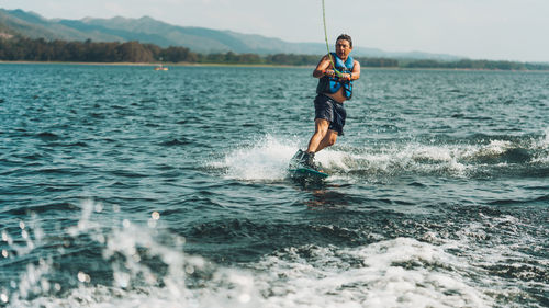 Full length of man doing wakeboard in a lake