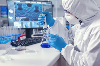 Midsection of scientist working in laboratory