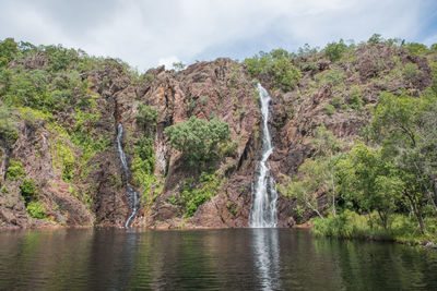 Scenic view of waterfall against sky