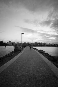 River amidst city against sky