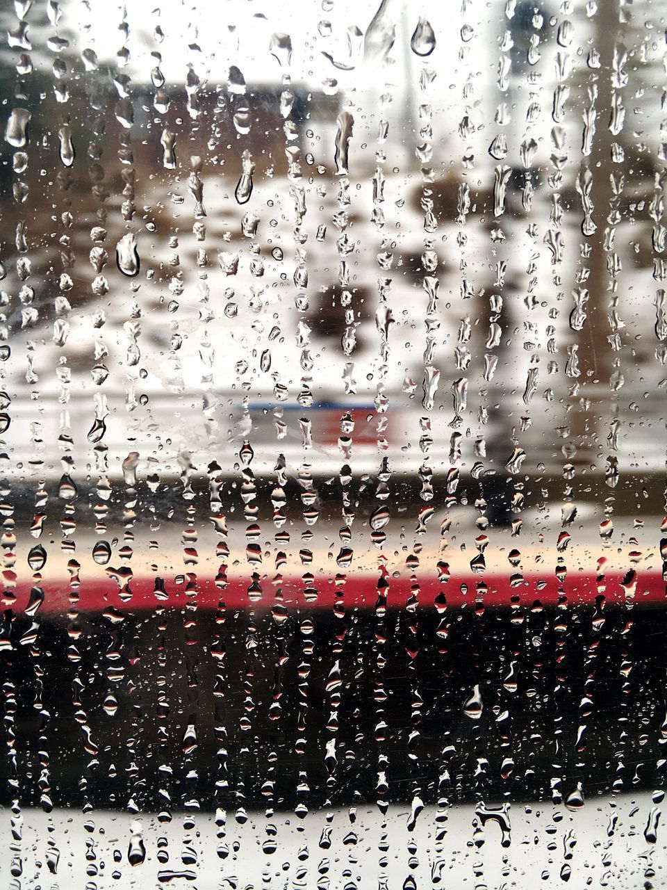 CLOSE-UP OF WATERDROPS ON GLASS WINDOW