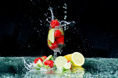 Close-up of fruits in glass against black background