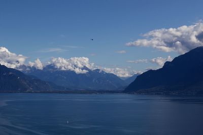 Scenic view of sea and mountains against sky