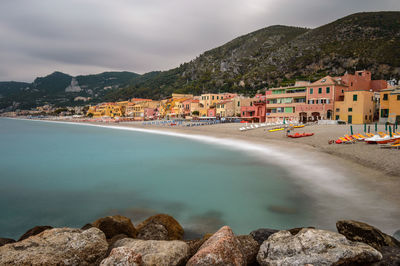 Panoramic view of sea and buildings against sky