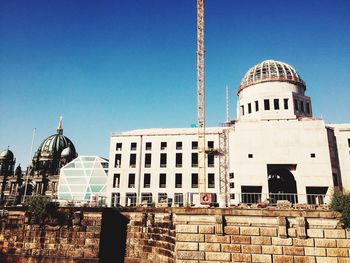 Low angle view of built structure against clear blue sky