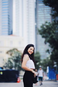 Portrait of woman standing in city