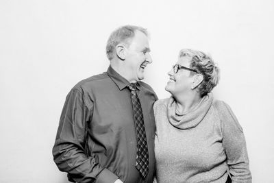 Couple kissing against white background