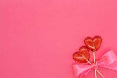 Close-up of heart shape against pink background