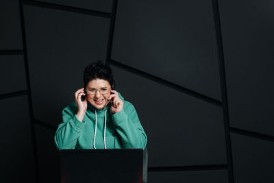 Portrait of smiling young man using mobile phone