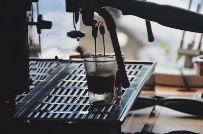 Close-up of coffee maker pouring coffee into cup