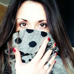 Close-up portrait of woman covering face with hand