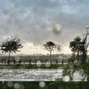 Scenic view of lake against sky during rainy season