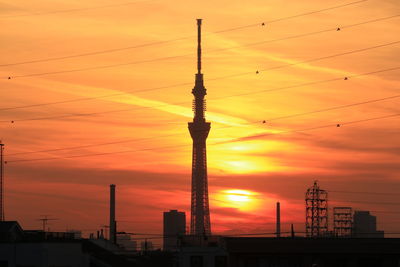 Silhouette of communications tower at sunset