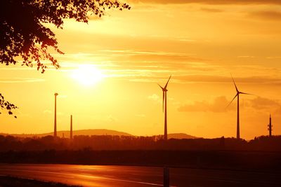 Silhouette of wind turbines at sunset