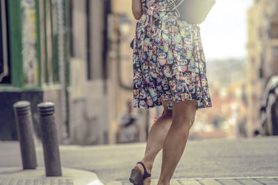 Low section of woman standing on street