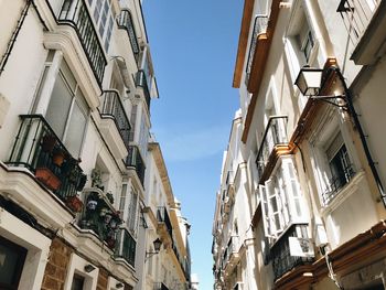 Low angle view of buildings against blue sky