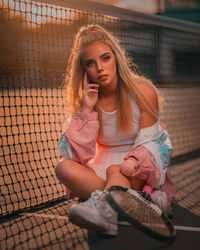 Portrait of young woman sitting outdoors