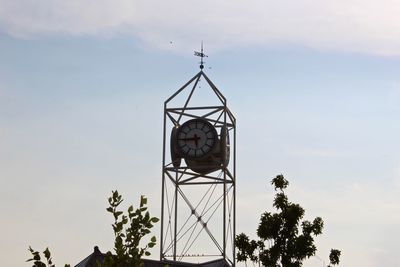 Low angle view of communications tower against sky