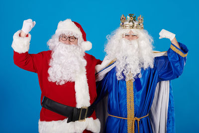 Portrait of woman wearing santa claus costume standing against clear sky