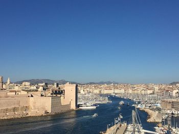 High angle view of buildings against blue sky