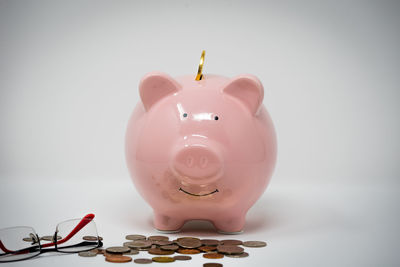 Close-up of coin against pink background